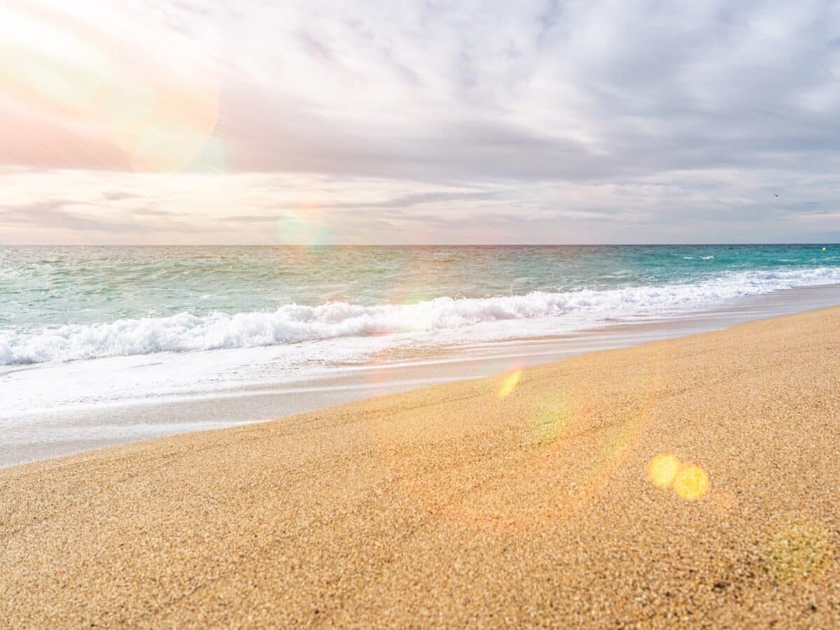 A,Serene,Beach,Scene,With,Golden,Sand,And,Turquoise,Ocean